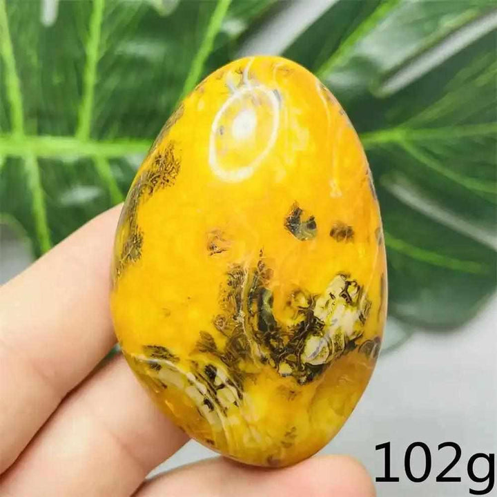 Smooth Bumblebee Jasper palm stone featuring vibrant yellow, orange, and black stripes for optimism and solar plexus energy.