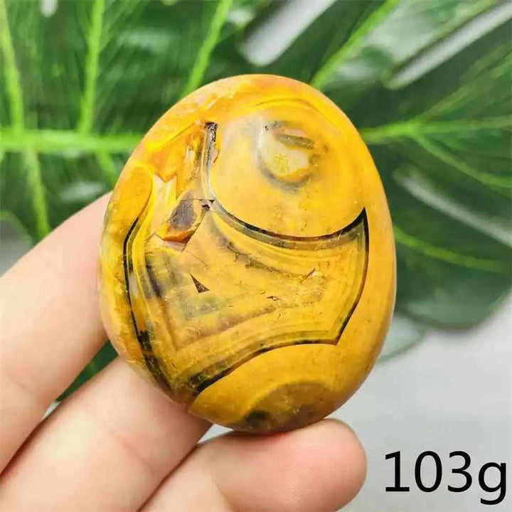 Smooth Bumblebee Jasper palm stone featuring vibrant yellow, orange, and black bands for optimism and energy.