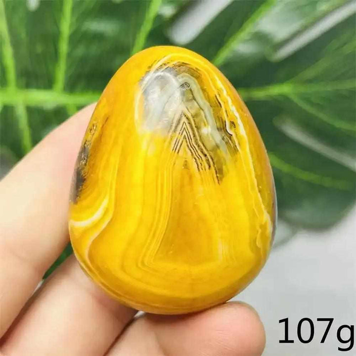 Smooth, hand-polished Bumblebee Jasper palm stone featuring vibrant yellow, orange, and black stripes for energy.