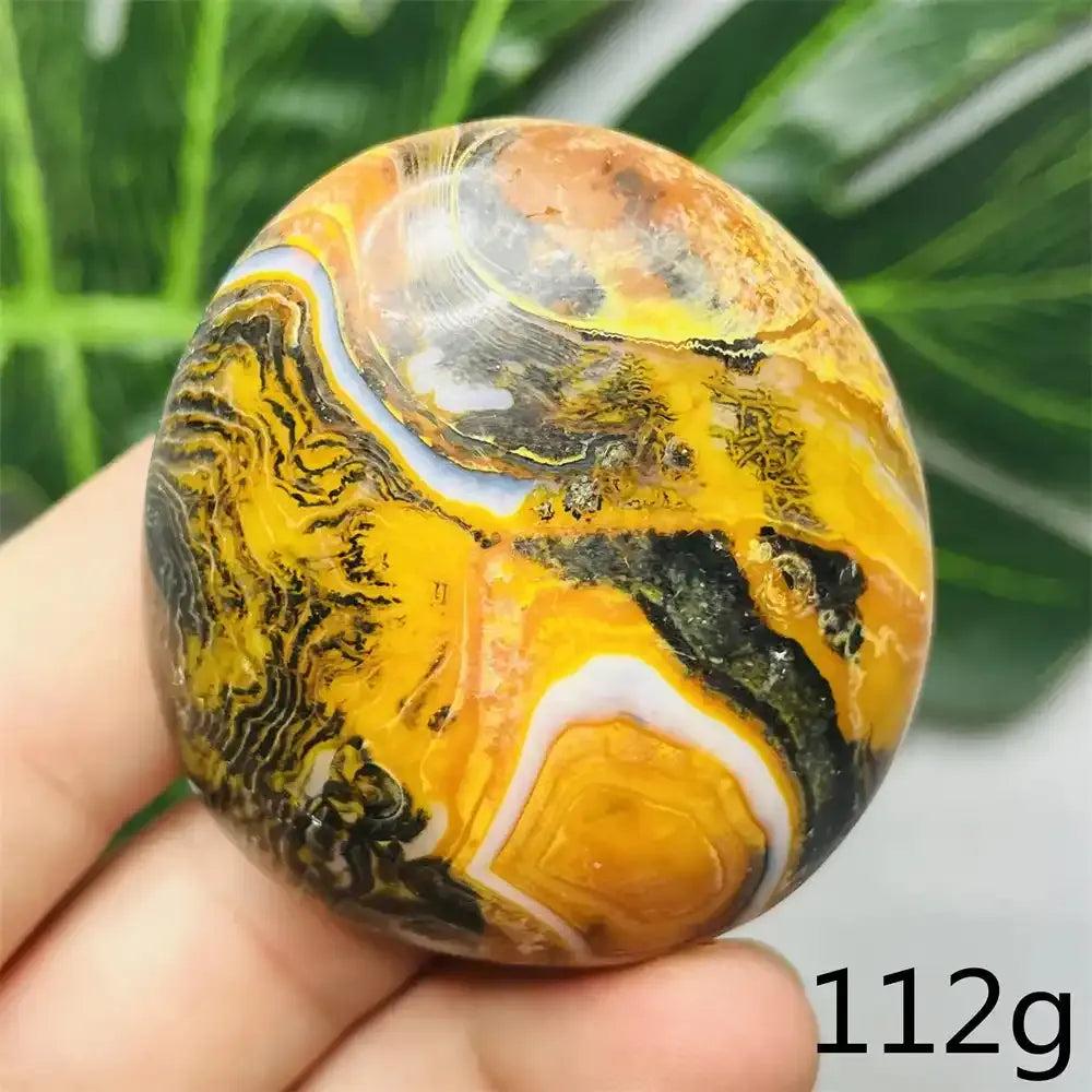 Smooth Bumblebee Jasper palm stone featuring vibrant yellow, orange, and black stripes for optimism and motivation.