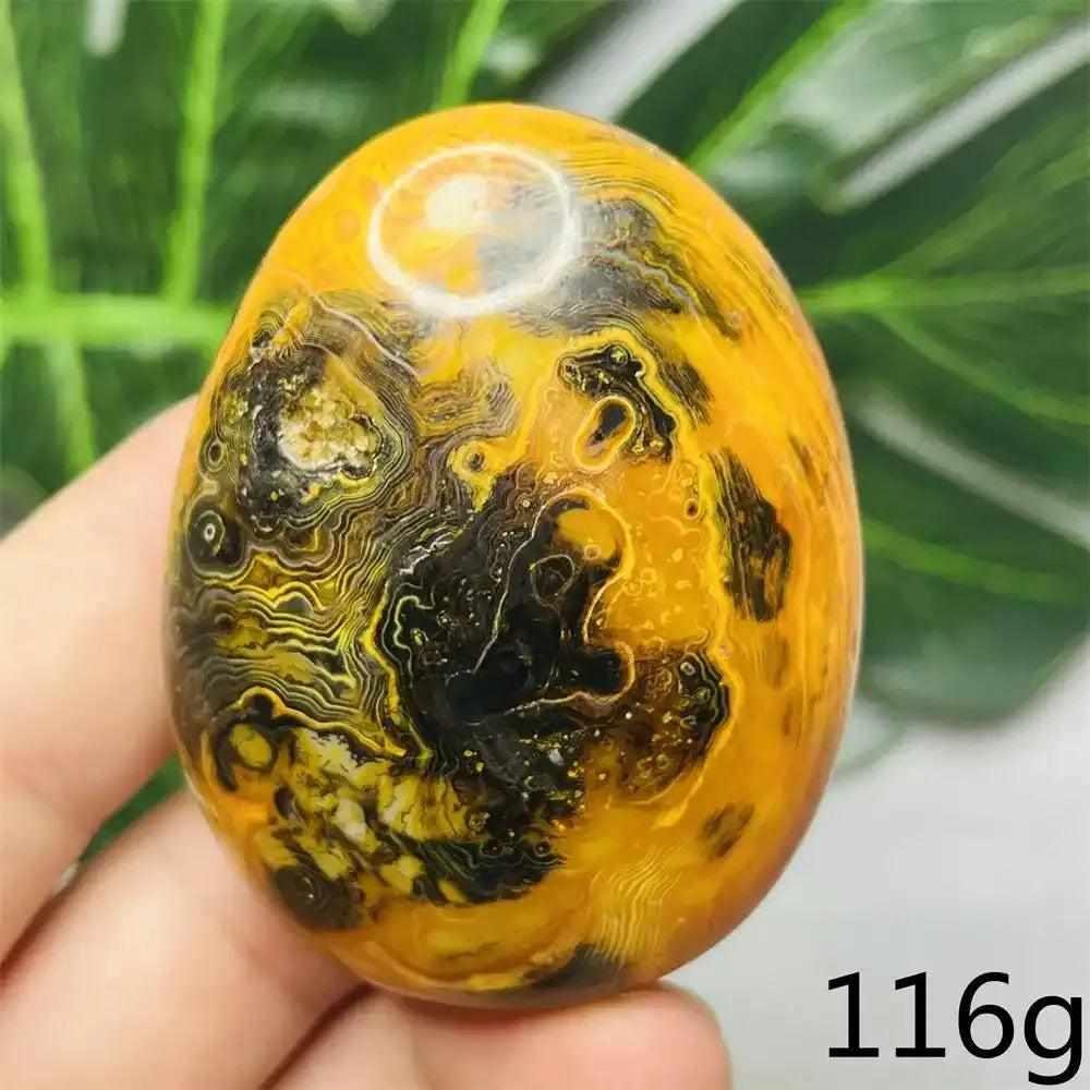 Smooth Bumblebee Jasper palm stone featuring vibrant yellow, orange, and black stripes for optimism and solar plexus energy.