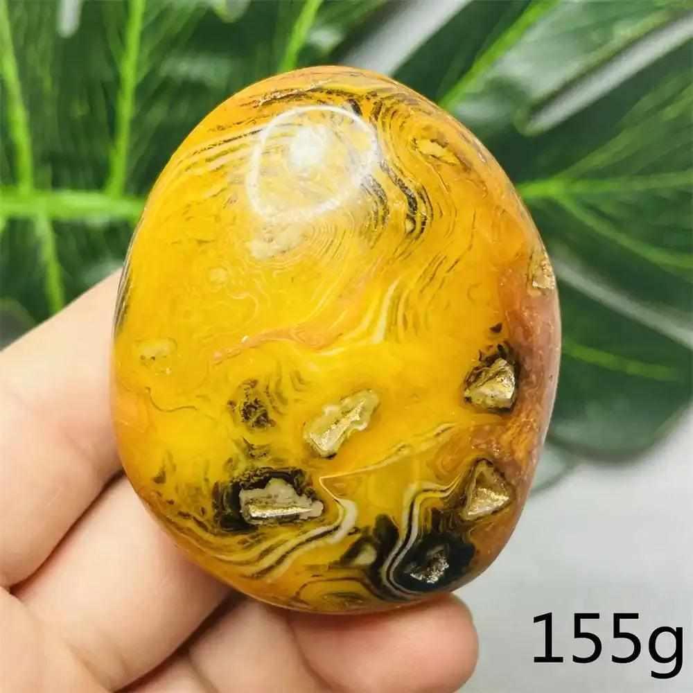 Smooth Bumblebee Jasper palm stone featuring vibrant yellow, orange, and black bands for optimism and energy.