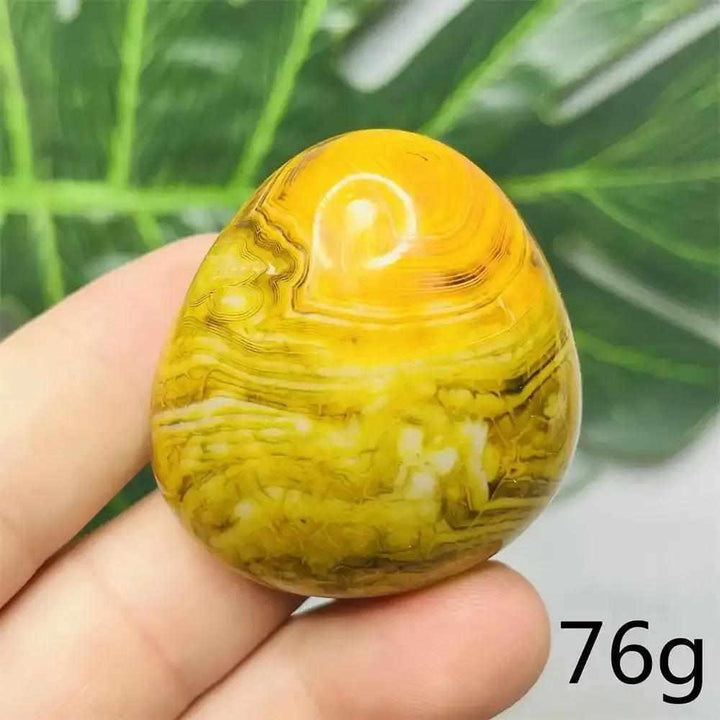 Smooth 76g Bumblebee Jasper palm stone featuring vibrant yellow, orange, and black stripes for optimism and motivation.