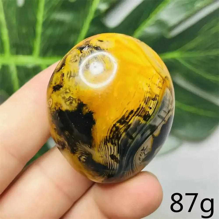 Smooth Bumblebee Jasper palm stone featuring vibrant yellow, orange, and black stripes for optimism and motivation.
