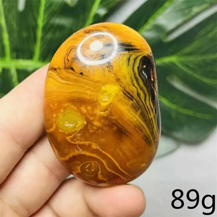 Smooth Bumblebee Jasper palm stone featuring vibrant yellow, orange, and black stripes for optimism and motivation.