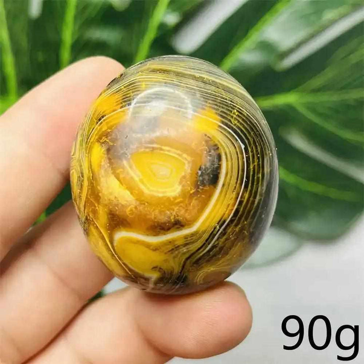 Smooth Bumblebee Jasper palm stone featuring vibrant yellow, orange, and black stripes for optimism and motivation.