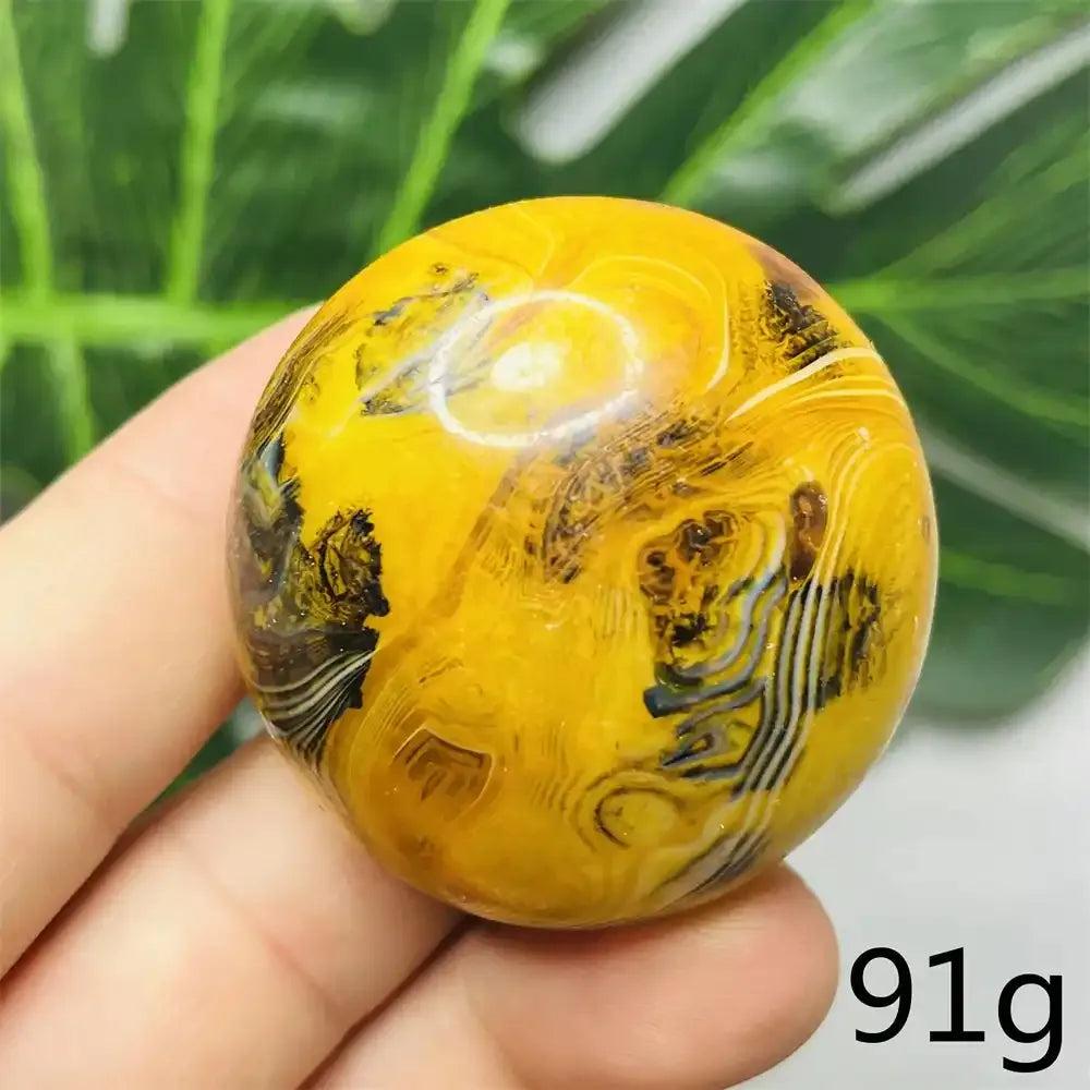 Smooth Bumblebee Jasper palm stone featuring vibrant yellow, orange, and black stripes for motivation and energy.