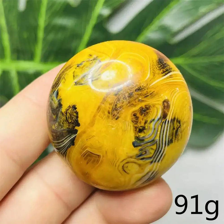 Smooth Bumblebee Jasper palm stone featuring vibrant yellow, orange, and black stripes for motivation and energy.