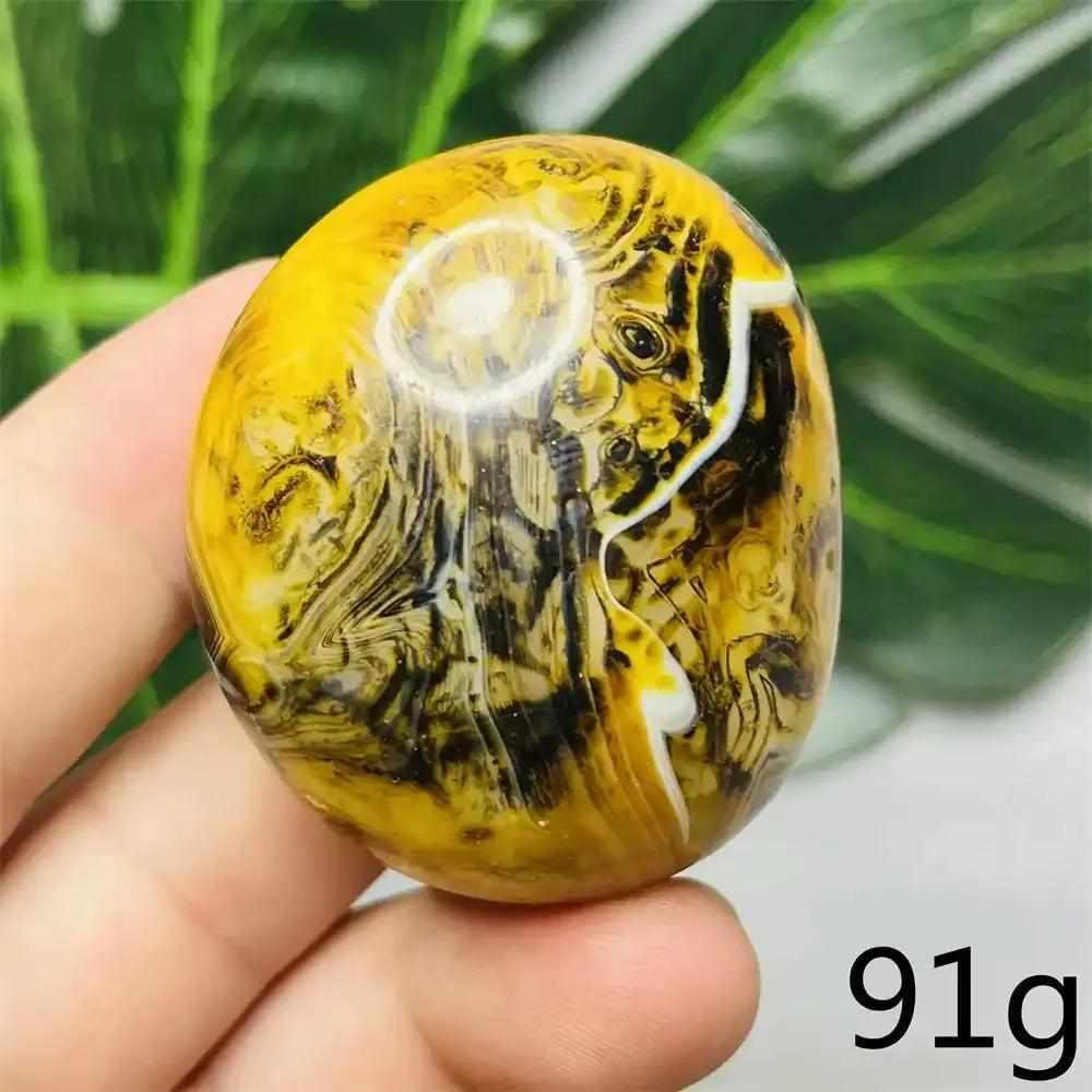 Smooth Bumblebee Jasper palm stone featuring vibrant yellow, orange, and black stripes for optimism and motivation.