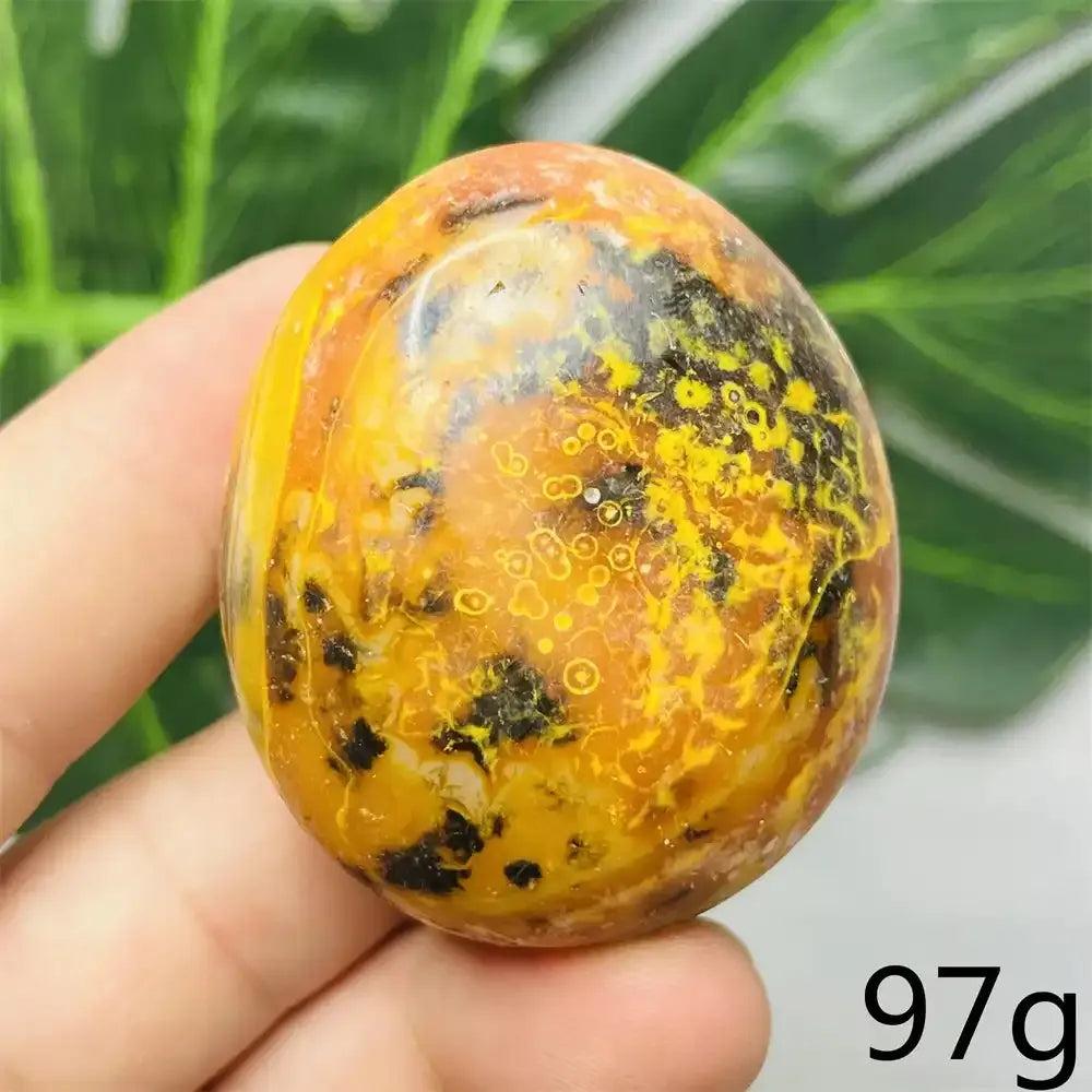 Smooth Bumblebee Jasper palm stone featuring vibrant yellow, orange, and black stripes for optimism and motivation.