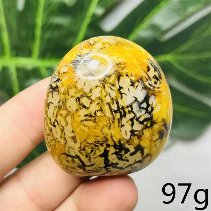 Polished Bumblebee Jasper palm stone with vibrant yellow, orange, and black stripes for solar plexus chakra energy.