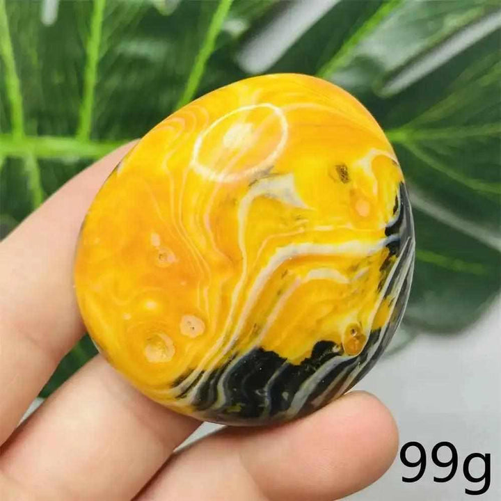 Smooth Bumblebee Jasper palm stone featuring vibrant yellow, orange, and black stripes for optimism and energy.