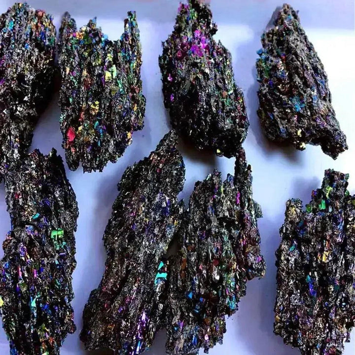 Carborundum Silicon Carbide Crystal Specimen Rainbow, raw iridescent pieces with deep blues, violet, gold, and green.