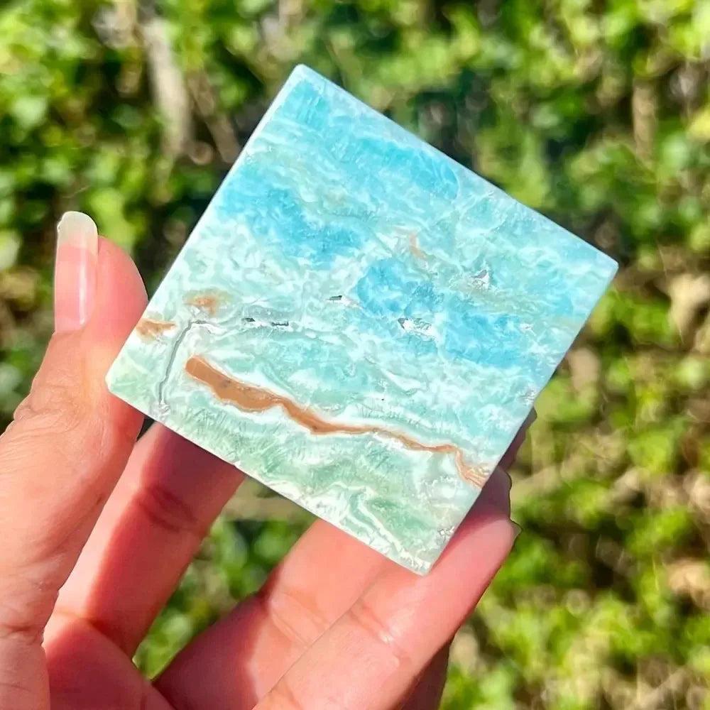 Caribbean Blue Calcite Crystal Cube from Crystal Destiny, featuring calming blue, white, and brown swirls.