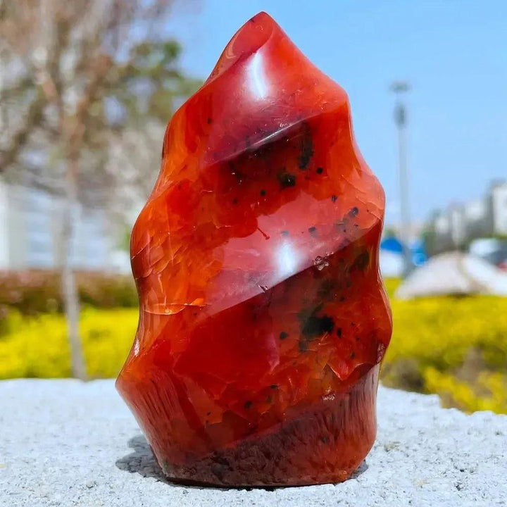 Vibrant Carnelian Crystal Flame, a hand-carved, polished fiery orange-red stone for vitality and creativity.