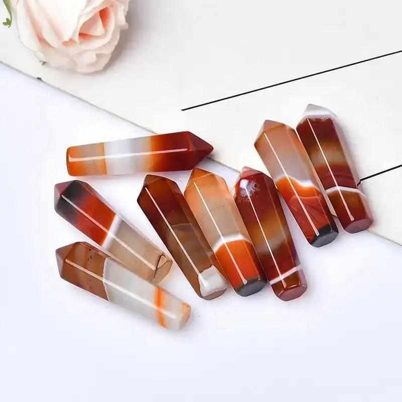 Polished 50-55mm Carnelian hexagonal crystal points in vibrant orange and red shades for energy and creativity.