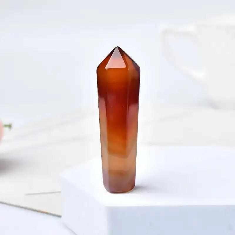 Polished 55mm carnelian hexagonal crystal point in warm orange and red, perfect for Sacral Chakra healing and creativity.