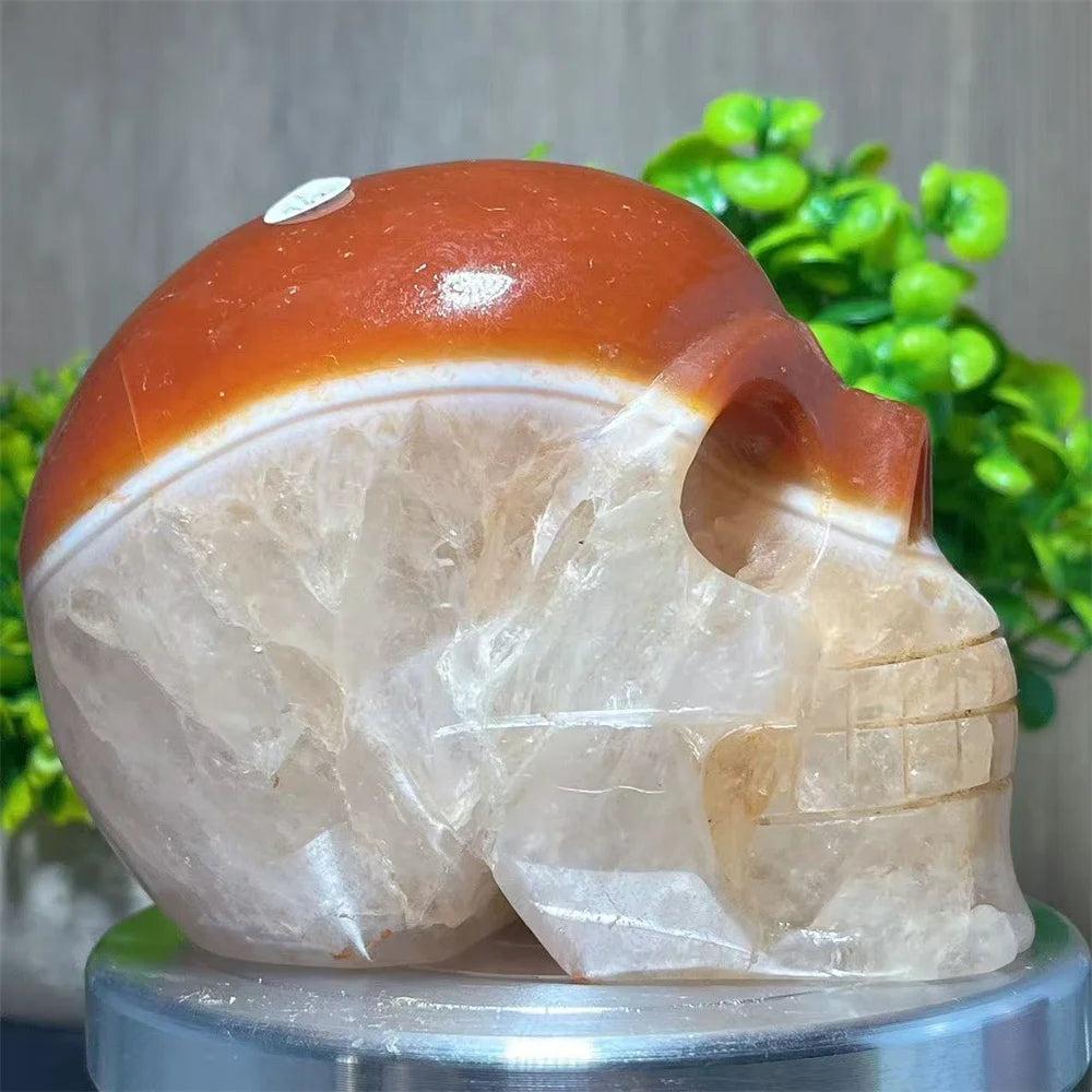 Carved Carnelian and Quartz crystal skull with warm orange and translucent white tones for grounding and reflection.