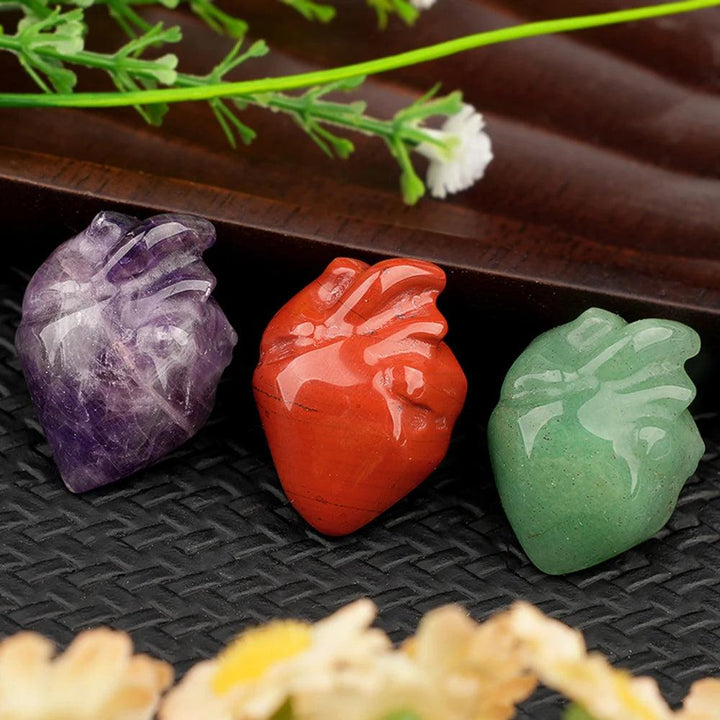 Amethyst, Red Jasper, and Green Aventurine crystal human heart model statues for reiki and decor.