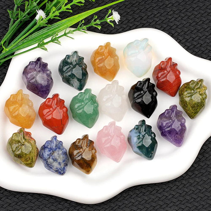 Assorted natural crystal human heart model statues, including amethyst, rose quartz, and obsidian, for decor and reiki.