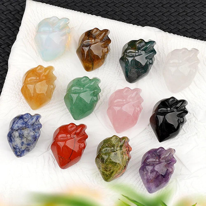 Assorted natural crystal human heart model statues, including amethyst, rose quartz, and obsidian, for decor and reiki.