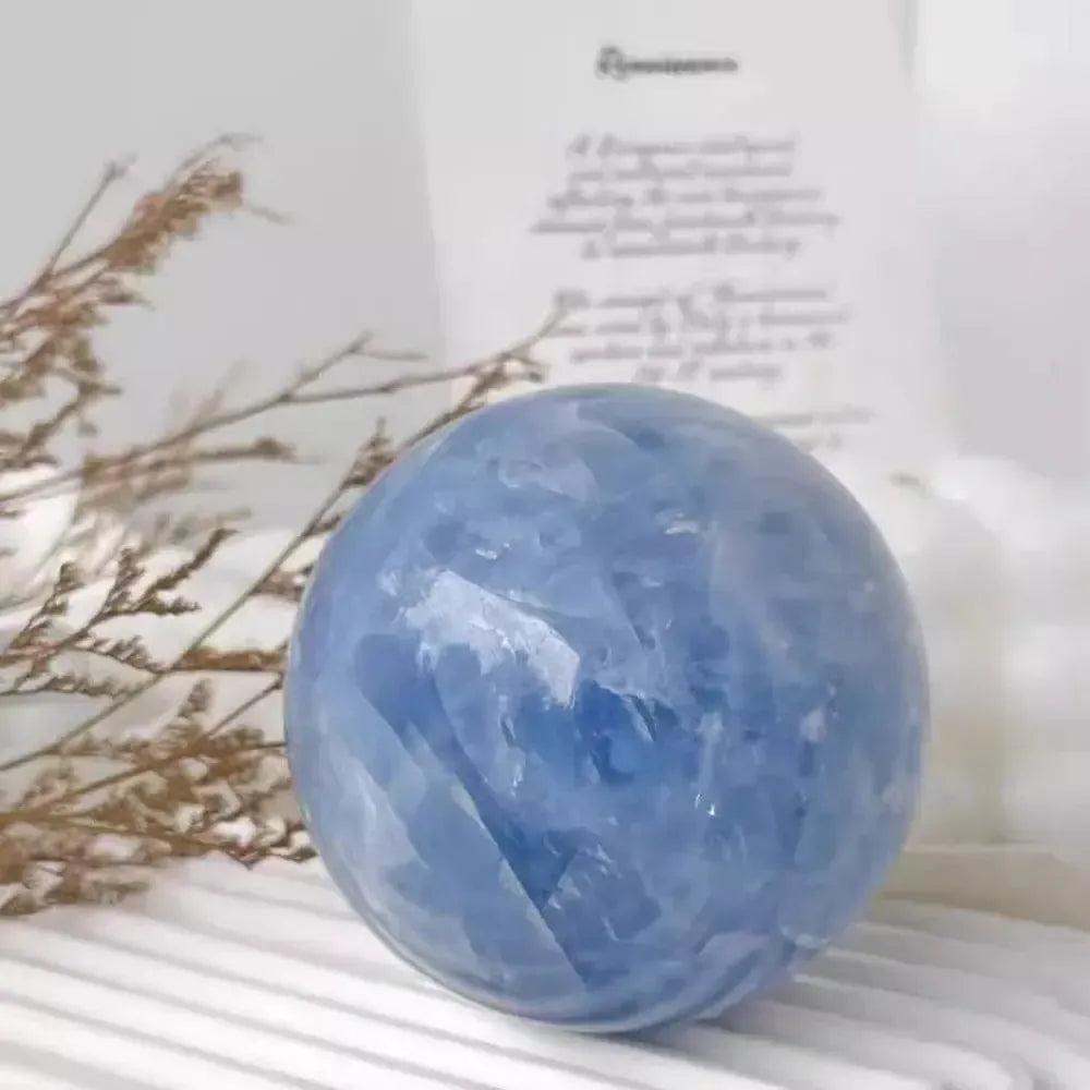 Hand-polished Celestite Crystal Sphere with soft blue hues, ideal for meditation and peaceful environments.