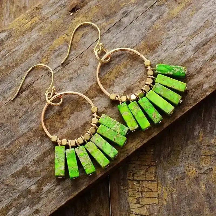 Gold-plated hoop earrings with vibrant green jasper rectangle beads, promoting balance and energy.