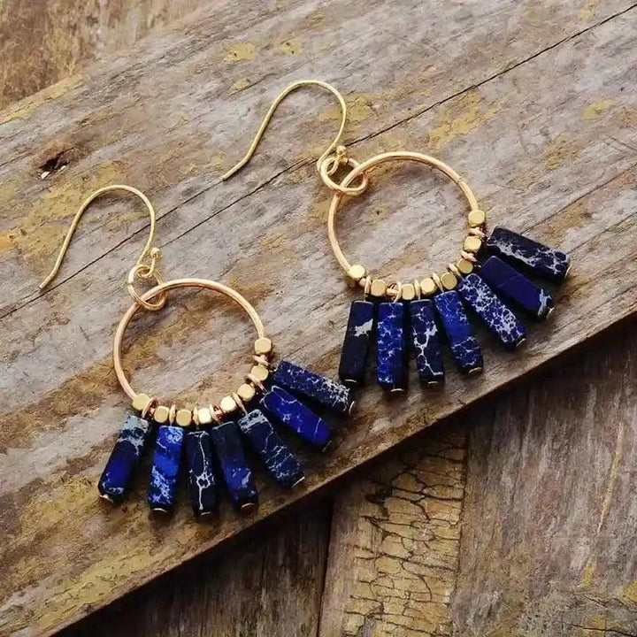 Gold-plated hoop earrings with vibrant blue imperial jasper dangle beads for spiritual wellness.