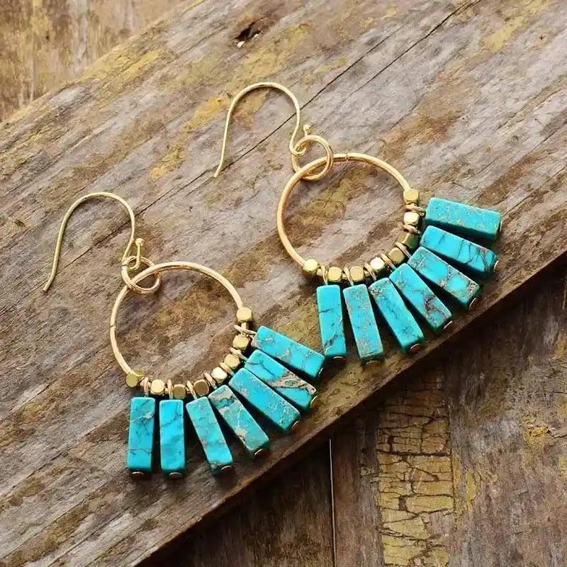 Gold-plated hoop earrings with vibrant turquoise bar beads, perfect for bohemian style and energy alignment.