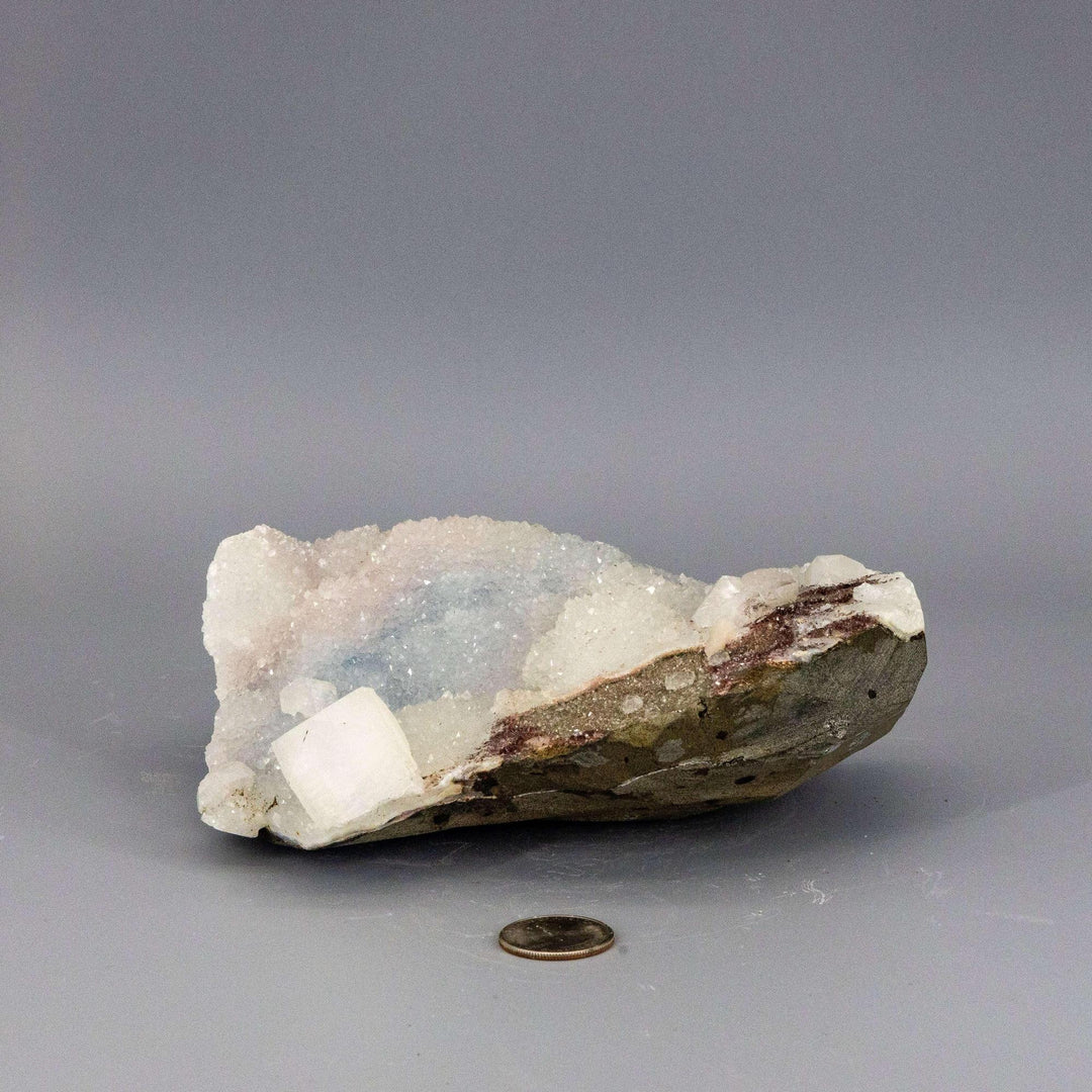 Waxy blue-grey Chalcedony Quartz cluster with a glassy, pyramid-tipped Apophyllite knob, showcasing serene beauty.