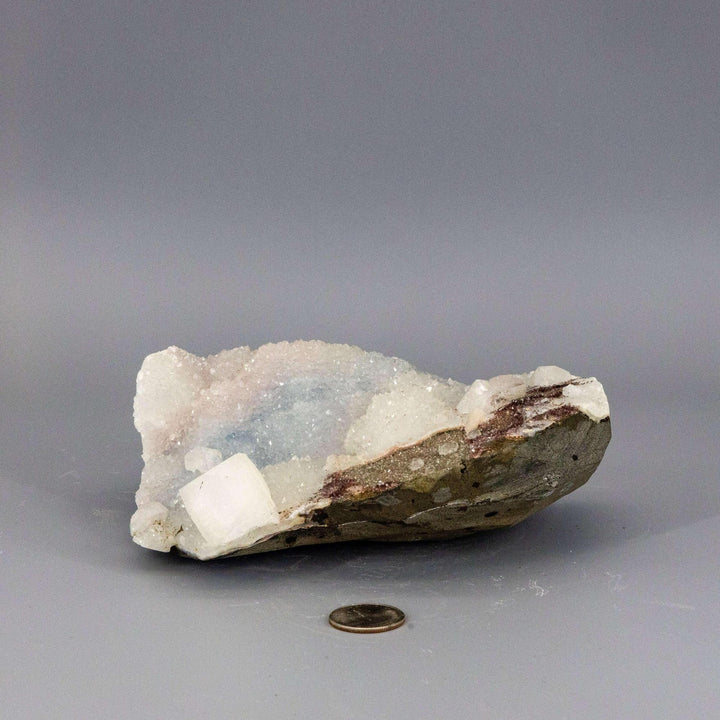 Waxy blue-grey Chalcedony Quartz cluster with a glassy, pyramid-tipped Apophyllite knob, showcasing serene beauty.
