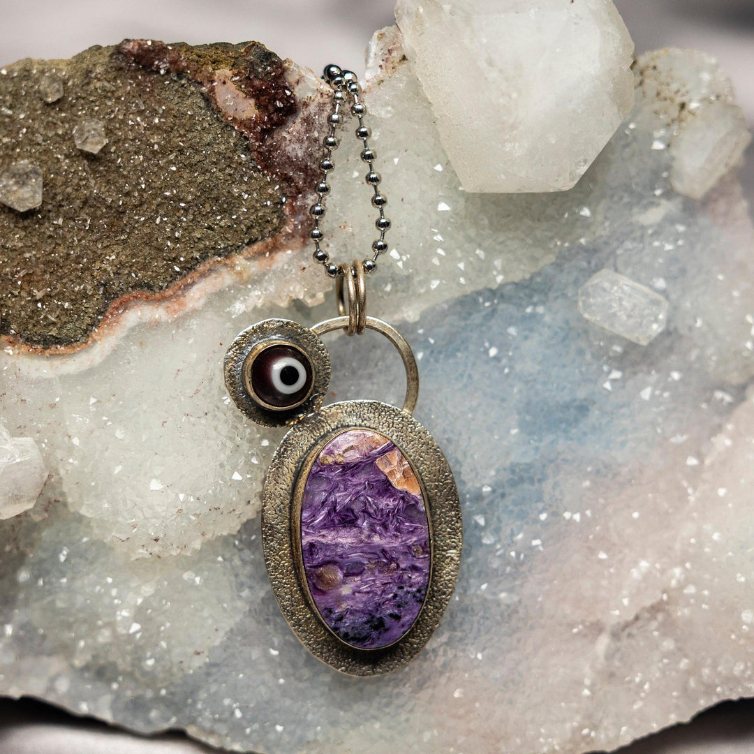 Charoite Evil Eye 925 Sterling Silver Pendant with swirling violet, lavender, and white hues for protection and transformation.