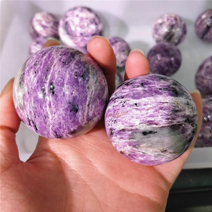 Polished Charoite crystal spheres featuring deep violet and lavender swirls for spiritual transformation and growth.