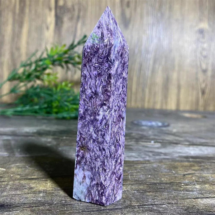 Rare Charoite Crystal Tower with deep, swirling violet, white, and black patterns, focusing Crown Chakra energy.