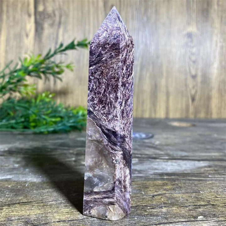 Rare Charoite Crystal Tower with deep, swirling violet, white, and black patterns, focusing powerful energy.