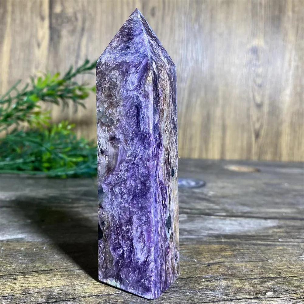 Charoite Crystal Tower with deep, swirling violet, white, and black patterns, a powerful natural stone wand specimen.