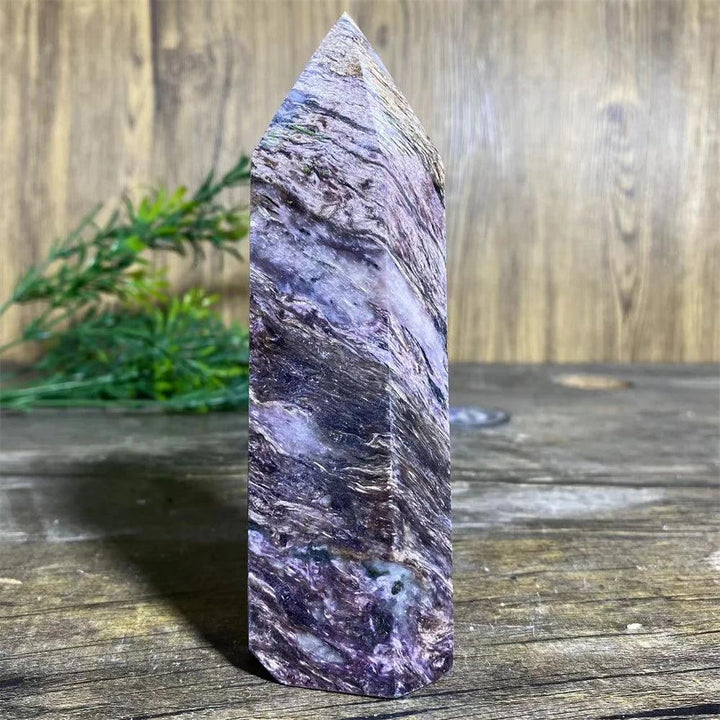 Charoite Crystal Tower with deep, swirling violet, white, and black patterns, a powerful natural stone wand specimen.