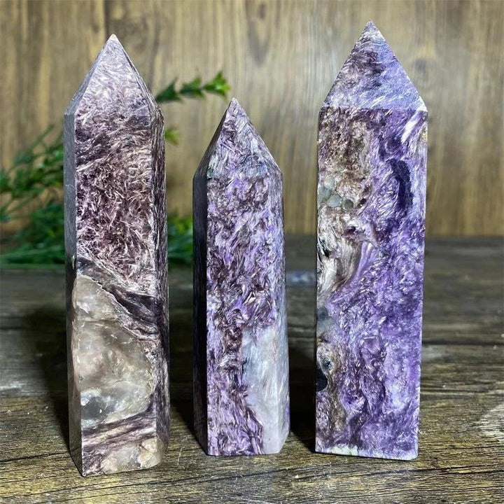 Three polished Charoite Crystal Towers with swirling violet, white, and black patterns, focusing crown chakra energy.