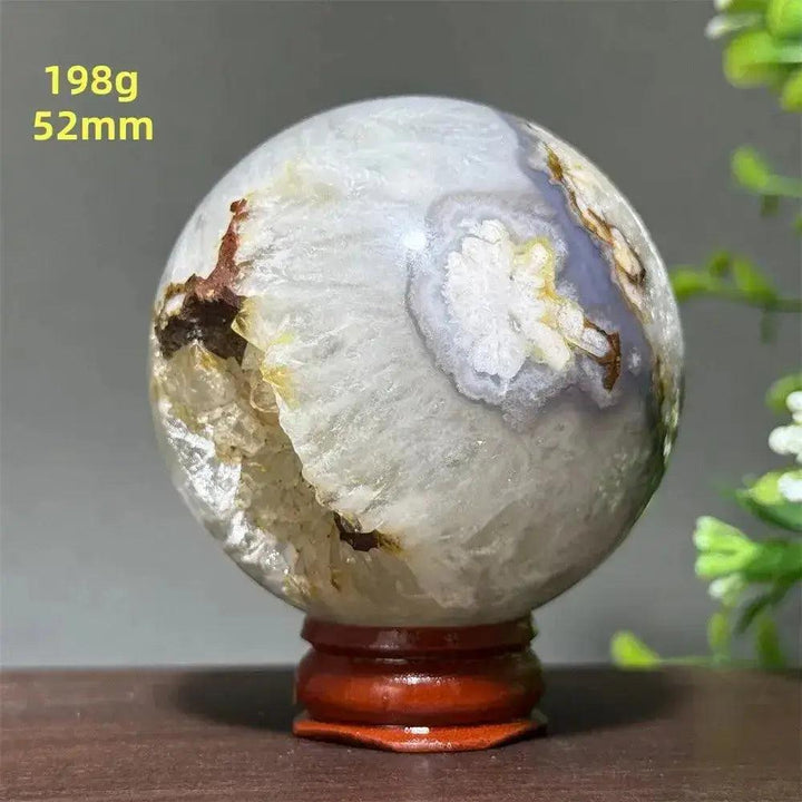Cherry Agate Crystal Sphere Meditation Energy, 52mm, 198g. Polished orb with unique red, pink, and white banding on a wooden base.