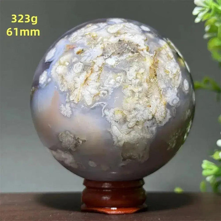 Polished Cherry Agate Crystal Sphere, 323g, 61mm, with unique white, gray, and gold banding on a wooden base.