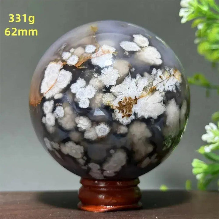 Cherry Agate Crystal Sphere, 62mm, 331g, with white, gray, and brown floral patterns on a wooden base.