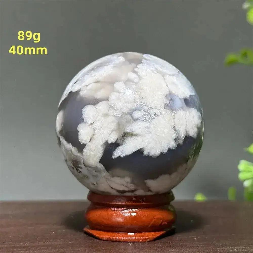 Cherry Agate Crystal Sphere: 40mm, 89g, with white cloud-like patterns on a gray base, on a wooden stand.