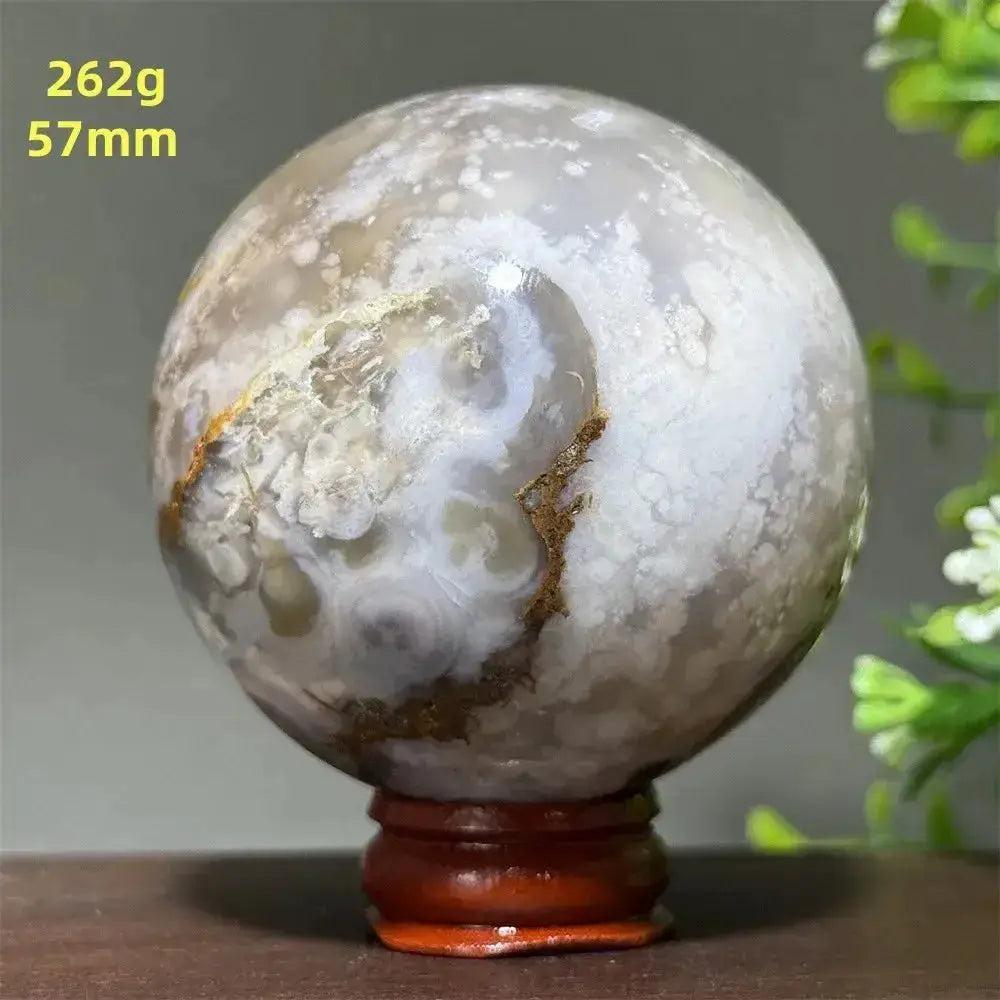 Polished Cherry Agate Crystal Sphere, 262g, 57mm, with unique white, grey, and brown banding on a wooden stand.
