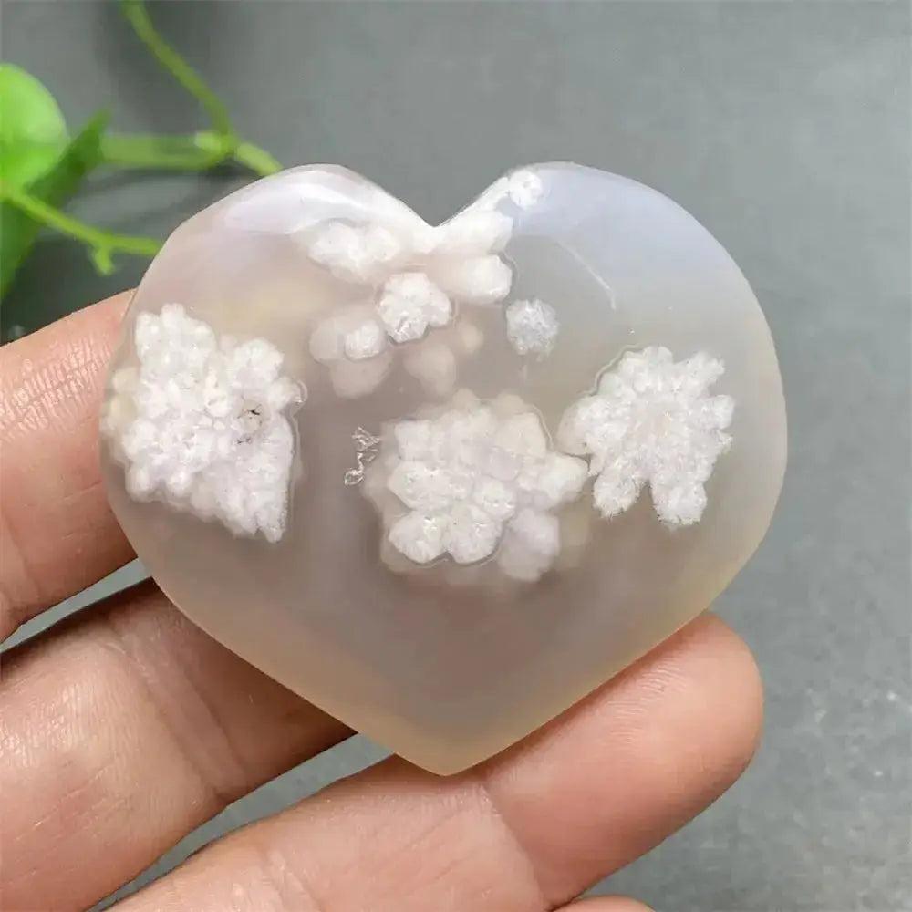Polished Cherry Blossom Agate Heart with delicate pink and white floral patterns, promoting emotional healing and self-love.