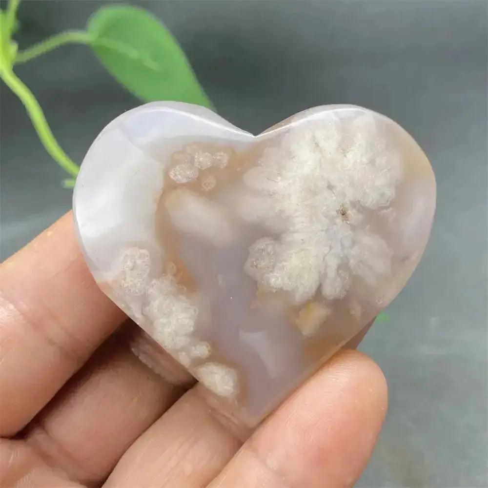 Cherry Blossom Agate Heart: Polished pink and white crystal heart, showcasing unique floral-like inclusions.