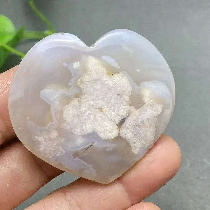 Cherry Blossom Agate Heart: Polished pink and white crystal heart with unique floral inclusions, promoting self-love.