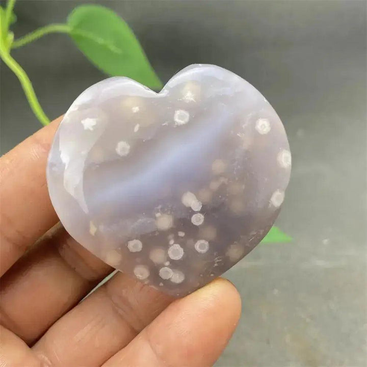 Polished Cherry Blossom Agate Heart with delicate pink and white floral patterns, promoting emotional healing and self-love.