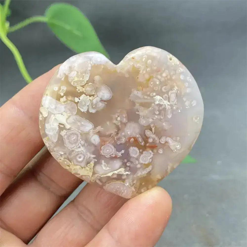 Polished Cherry Blossom Agate Heart with delicate pink and white floral patterns, promoting emotional healing and self-love.