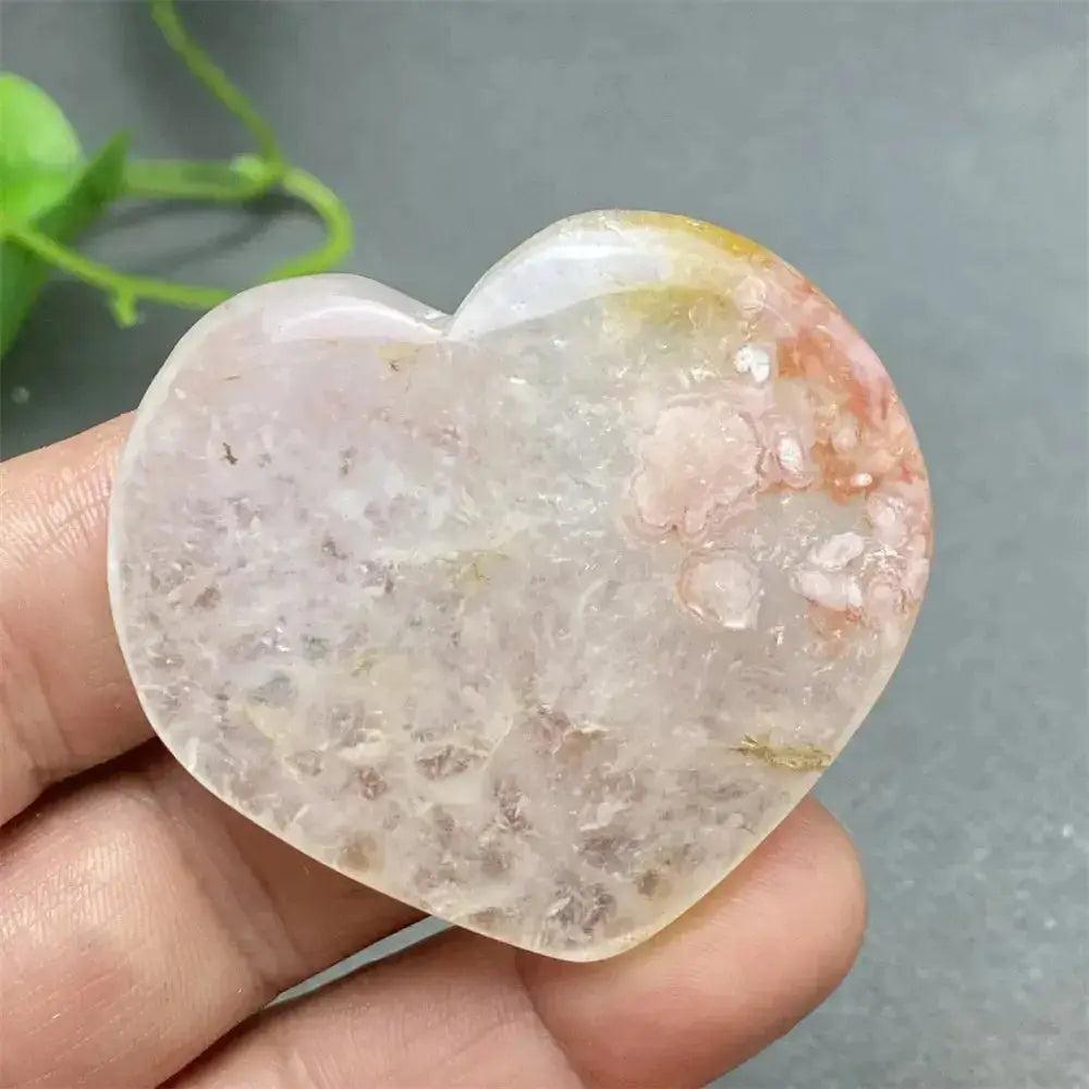 Cherry Blossom Agate Heart: Polished pink and white crystal heart with unique floral inclusions, promoting self-love.