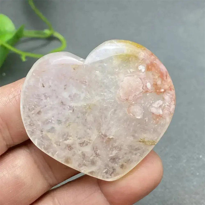 Cherry Blossom Agate Heart: Polished pink and white crystal heart with unique floral inclusions, promoting self-love.